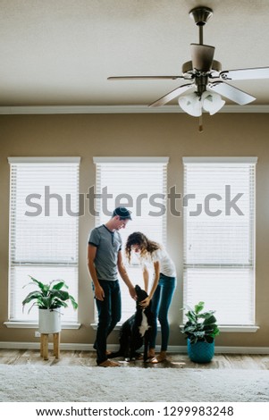Happy Couple at home with Dog