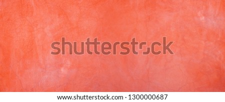 The background of the stucco wall  Color of the year 2019: Living Coral. Abstract texture rough wall surface decorated in modern soft orange pantone.