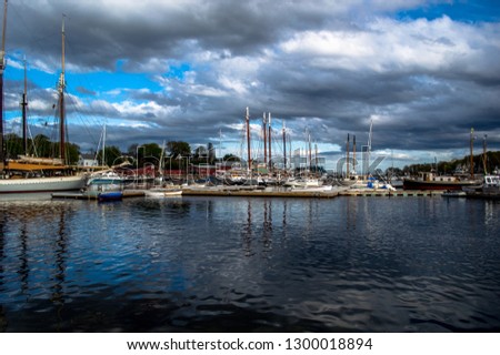 Beautiful view of Camden Harbor in Maine over the summer. The sky is slightly stormy which gives the photo a good aesthetic.