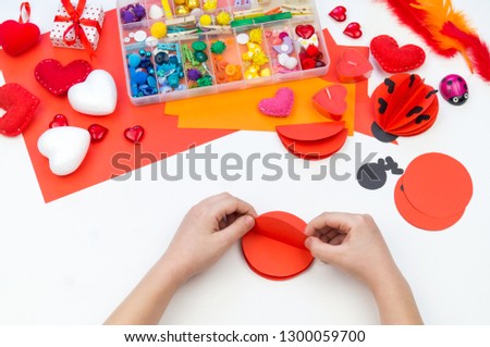 Ladybug made of paper. Red love symbol. Children's hand-made paperwork for Valentine's day feast. Materials for creativity.
