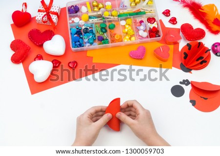 Ladybug made of paper. Red love symbol. Children's hand-made paperwork for Valentine's day feast. Materials for creativity.
