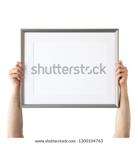 Holding frame mockup. Photo Mockup. Man hands hold frame. For frames and posters design. Frame size 16x12 (40x30cm).