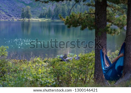 Russia, Siberia, Altay, Relax in hammock near lake