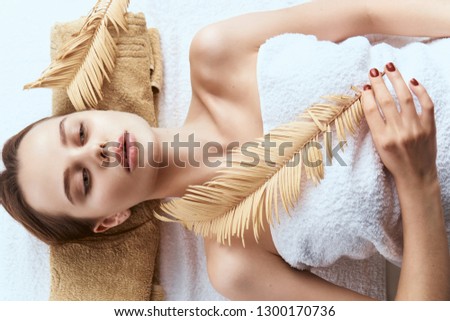   relax woman with feather spa beauty care massage                             