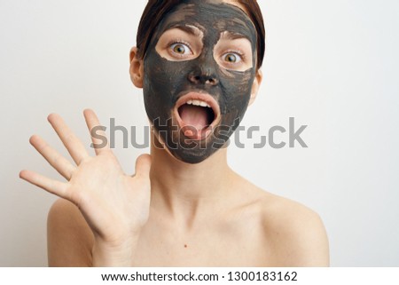 woman in a cosmetic mask shows palm