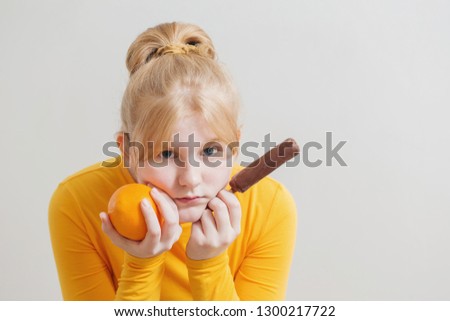 girl with orange and ice cream on white background