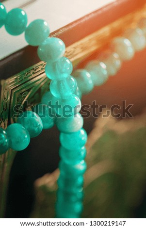 Muslim prayer beads on wooden background close up