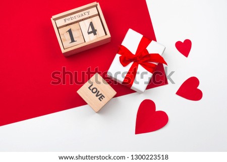 Valentines day greeting card. gift box on red table. Top view with copy space