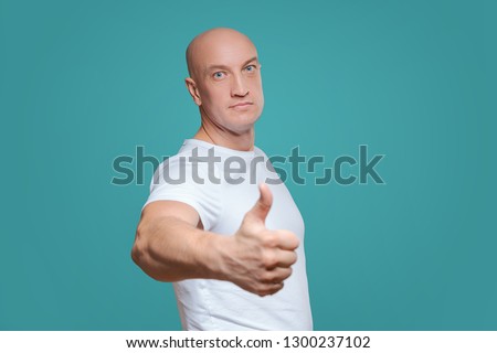 an emotional man in a white t-shirt shows with a hand gesture that everything is cool, on a Titian background