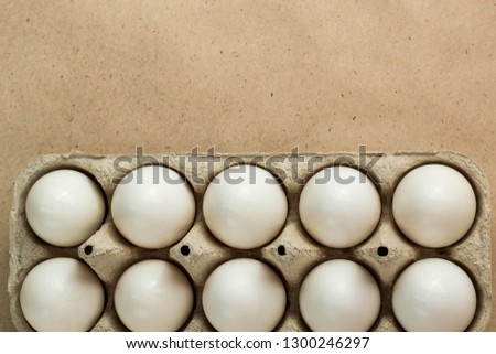 Cardboard egg rack with eggs on rustic background with copy space for text