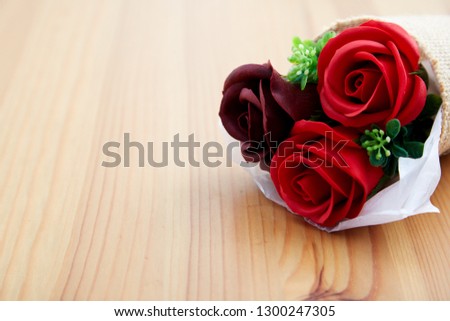 A couple gift roses on valentine day on wooden table in the kitchen, empty space for design