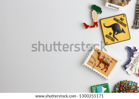 Magnet souvenirs from all around the world on white refrigerator. Travel concept.