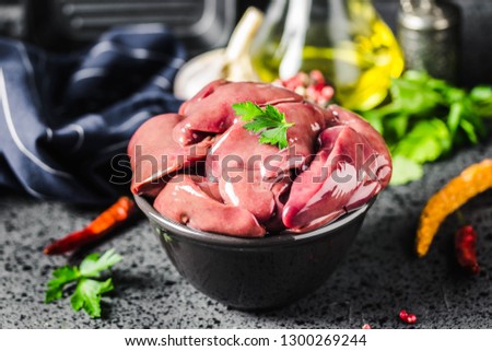 Chicken liver on dark background. Selective focus, space for text.