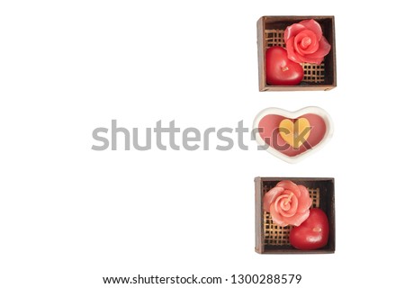 Handmade Red heart shaped candles and red rose candles in a wooden box isolated on white background, The Valentine's day concept, Holiday card with copy space, Happy celebration and anniversary