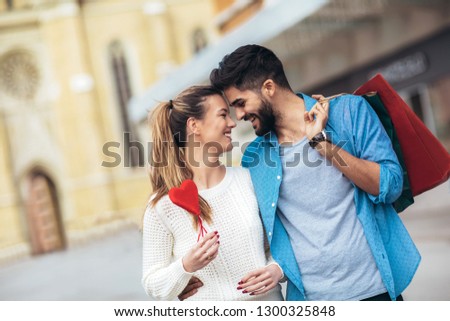 Happy couple shopping together for Valetine's day and having fun. Royalty-Free Stock Photo #1300325848