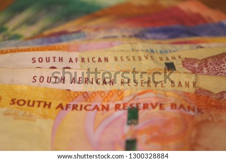 Close-up picture of rand banknotes. The Rand is legal tender in the Common Monetary Area between South Africa, Swaziland (Eswatini), Lesotho, and Namibia.