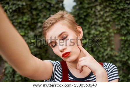 Woman in a sundress on the nature near the bushes                               