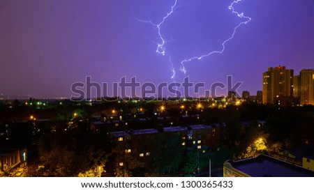 Lightning strike in the city Kyiv. Storm outside. Thunderstorm with lightning in the city. Moment lightning