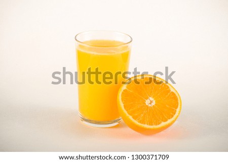 orange and orange juice in a mirror