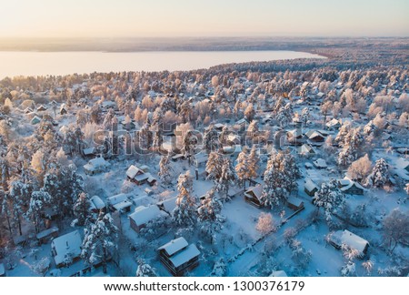 Winter view of russian country suburban village settlement, russian village, aerial sunny drone shot, near Saint-Petersburg
