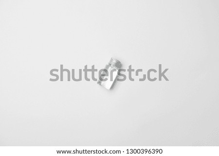 Top view of transparent cometic bottle on white background with copy space