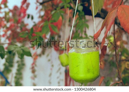 Green recycled glass jar as garden lamp