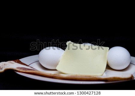 bacon, eggs and cheese on a plate