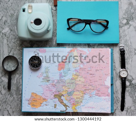  Travel planning dreams. Map of the world. Travel, tourism and vacation concept background. Stylish notebook, map and magnifier. Flat lay.