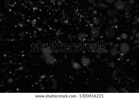 Abstract splashes of Rain and Snow Overlay Freeze motion of white particles on black background Royalty-Free Stock Photo #1300456225