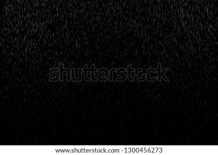 Abstract splashes of Rain and Snow Overlay Freeze motion of white particles on black background Royalty-Free Stock Photo #1300456273