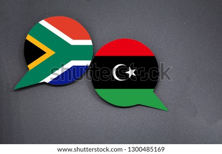 South Africa and Libya flags with two speech bubbles on dark gray background