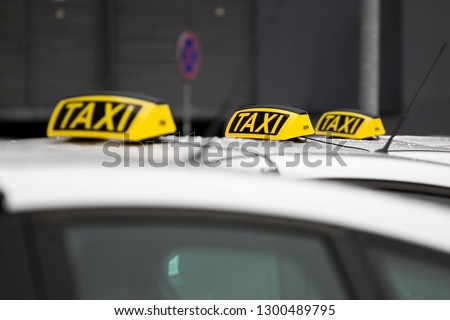 A taxi is waiting for a passenger  Royalty-Free Stock Photo #1300489795