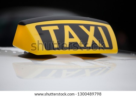 A taxi is waiting for a passenger  Royalty-Free Stock Photo #1300489798