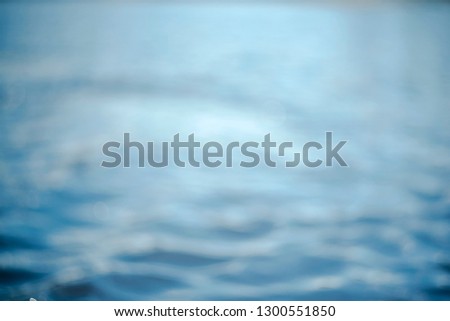 Beautiful underwater sea scene with natural light rays, shining through the water's glittering and bokeh. Natural bokeh blue blur view of water surface backgrounds. Bokeh light background in the pool.