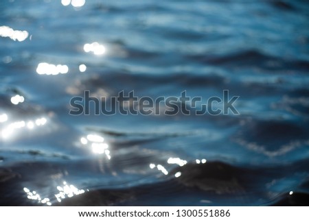 Beautiful underwater sea scene with natural light rays, shining through the water's glittering and blurred bokeh. Natural bokeh blue  blur view of water surface backgrounds. 