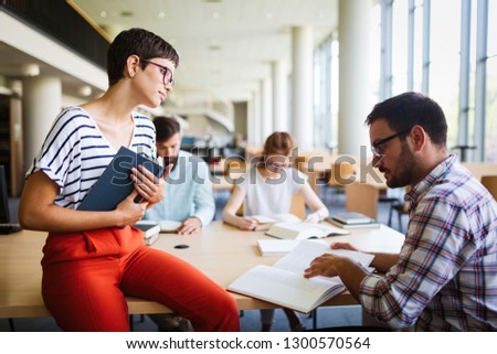 Students preparing together the examinations in a modern library