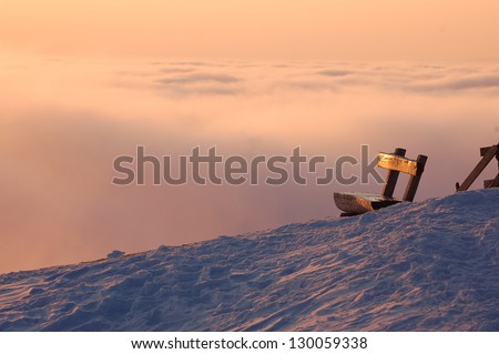 Winter landscape with a bench, on the mountain Rigi, Switzerland
with enough copy space for your text on a cloudy background