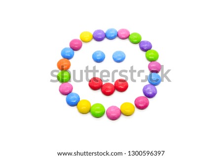 Face with expression of emotions, smiley from multicolored candies isolated on white background
