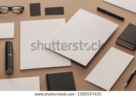 Flat lay with cards, notebook, glasses, marker pen, case, pen sheets of paper