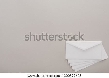 top view of white envelopes on grey background 