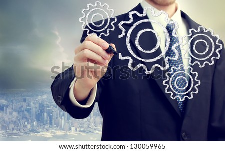 Businessman with gears - concepts of teamwork, efficiency, interlocking parts.