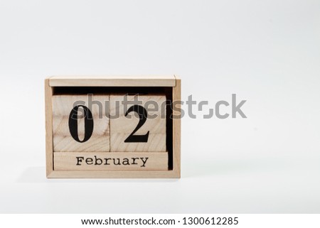 Wooden calendar February 02 on a white background close up