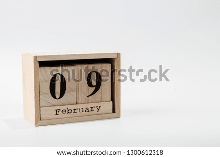 Wooden calendar February 09 on a white background close up