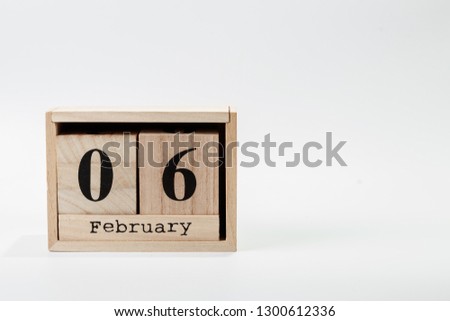 Wooden calendar February 06 on a white background close up