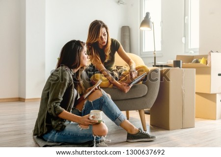 Female couple making plans for new apartment