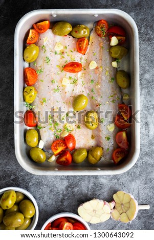 Delicious white fish with olives, capers, tomato and herbs.
