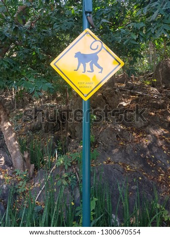 Warning Sign​ Keep away from the monkey​ which​ it is located on a mountain in the forest