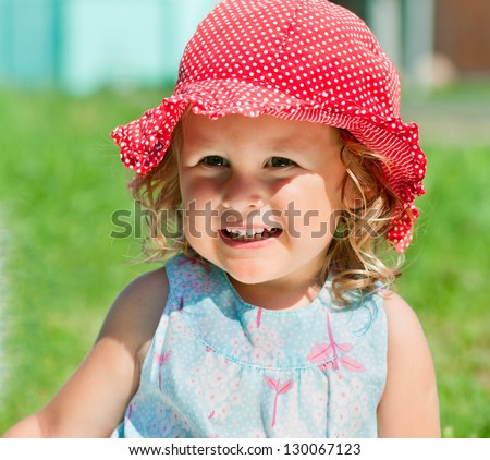 Baby girl in sunhat outdoors