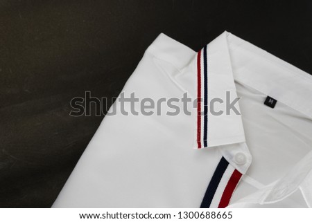sale, shopping, fashion, style  concept - selective focus on white shirt on black  background with copy space. Flat lay, Top view.
