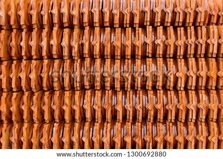 Stack of roof tiles traditional clay for temple construction process in vintage style which textured of surface natural color background.